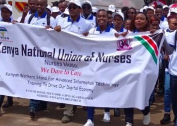 Nurses matching flagging their kenya national union of nurses flier during labour day celebrations. photo knun
