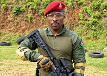 Former KDF soldier Patrick Osoi in military-style uniform and red beret.