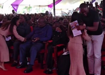 Edwin Sifuna stands to greet Njeri Maina during Martha Karua’s father’s funeral